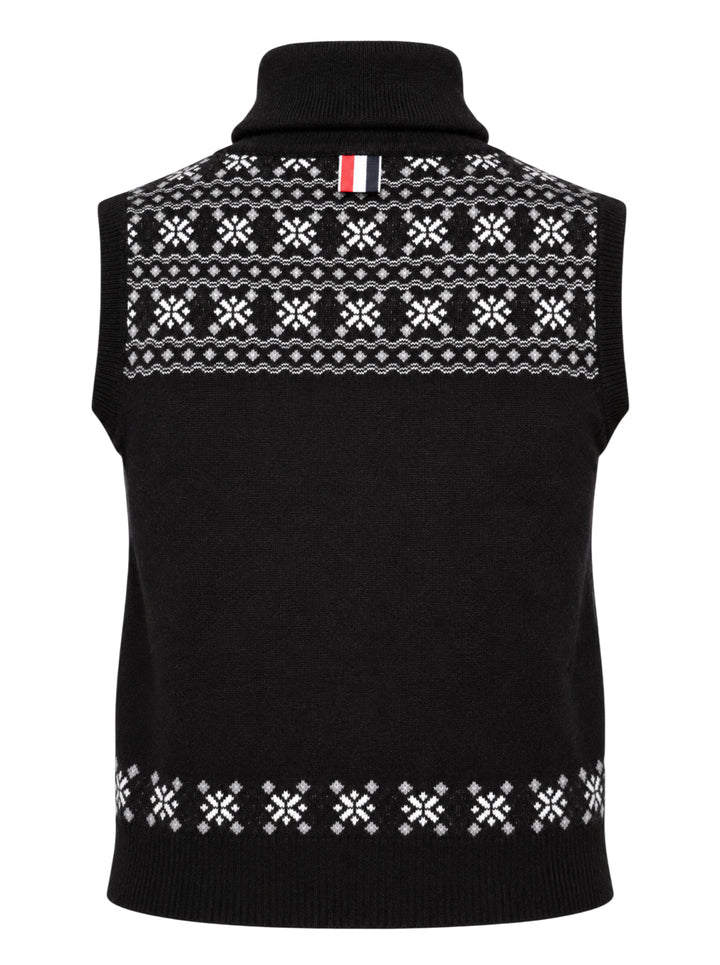 Black sleeveless turtleneck knit vest with white and grey Icelandic Fair Isle snowflake pattern across the yoke and hem - view 2