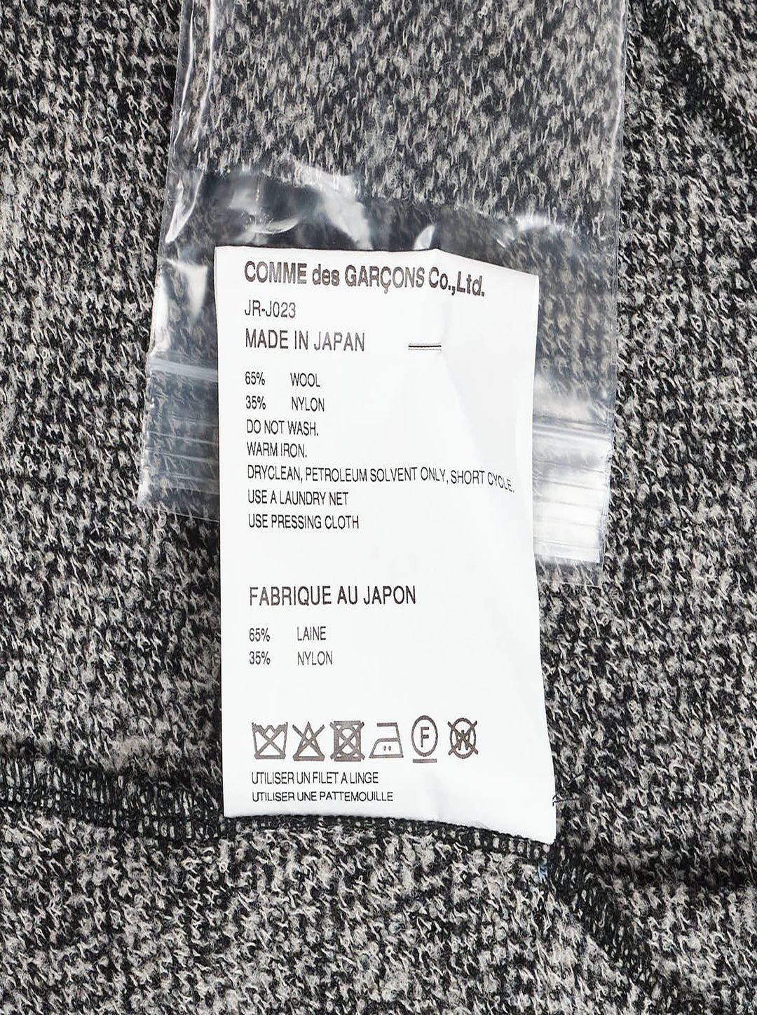 Junya Watanabe black and white houndstooth double-breasted structured coat with oversized silhouette, four black buttons, and large hip pockets, flat lay on white background - view 3
