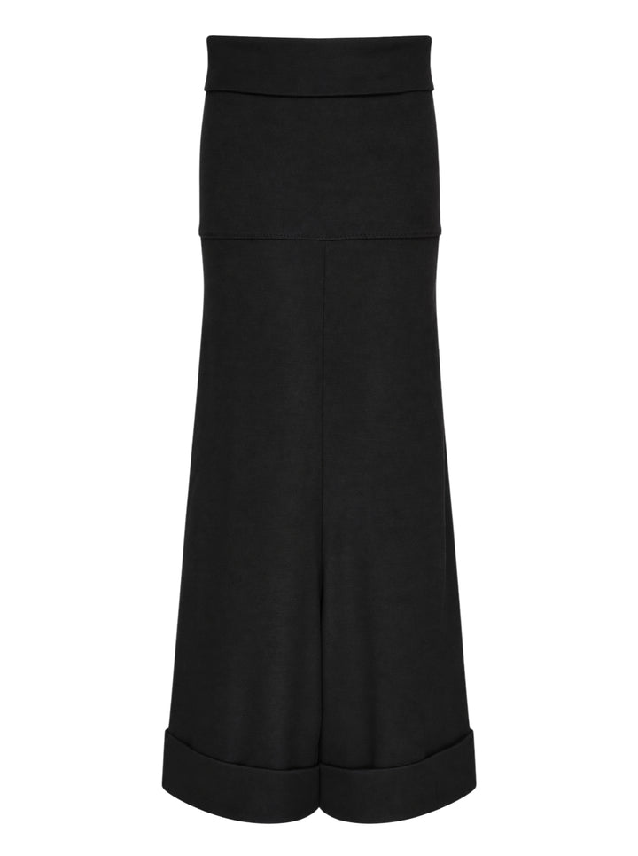 Junya Watanabe straight-leg minimal pants in black, featuring a fold-over waistband, wide silhouette, centre-front seam, and deep turned cuff at the hem, displayed flat on a white background