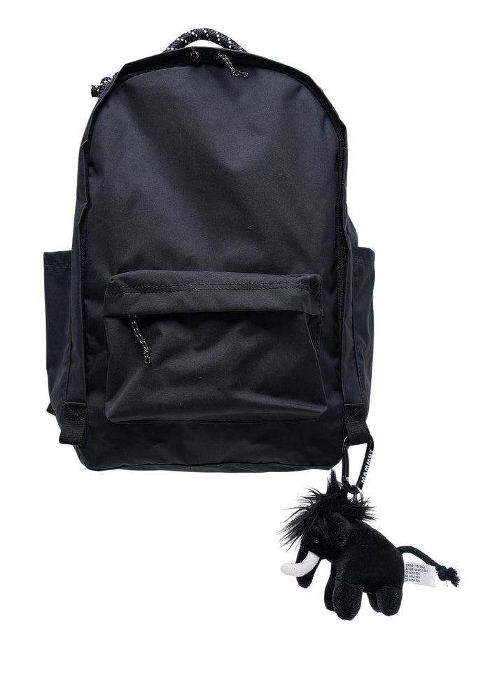 Junya Watanabe x Mammut black backpack with front zip pocket and a plush black mammoth charm clipped to the base