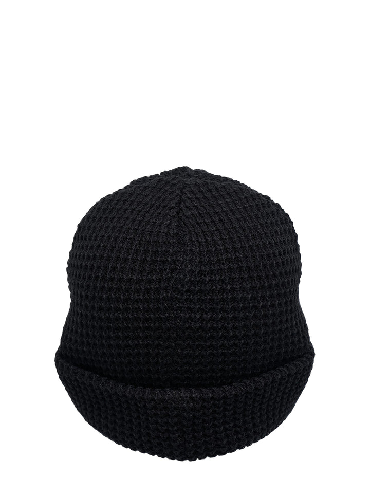 Black waffle-knit cuffed beanie with an embroidered abstract face patch and KS initials on the front - view 2