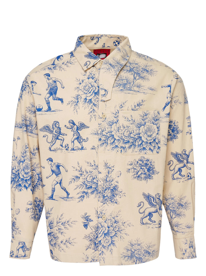 KidSuper Studios cream long sleeve button-up shirt with blue toile de Jouy print of footballers, winged griffins and peonies, with asymmetric collar and chest pocket