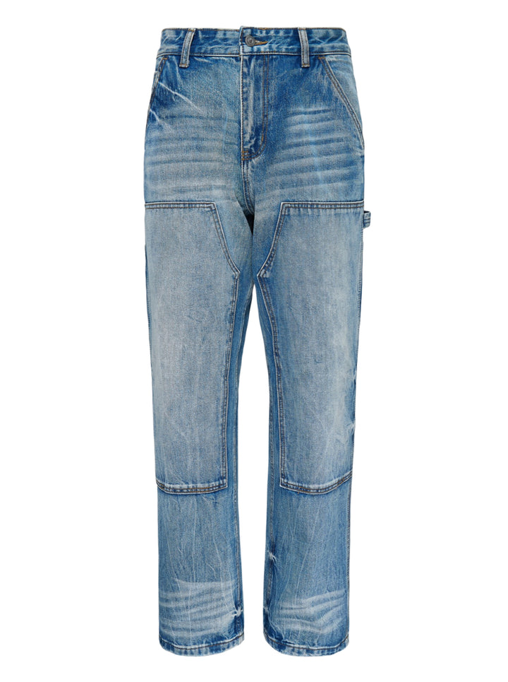 KidSuper Studios Eye Badge washed double knee jeans in faded blue denim with contrast topstitching and utility hammer loop, front view