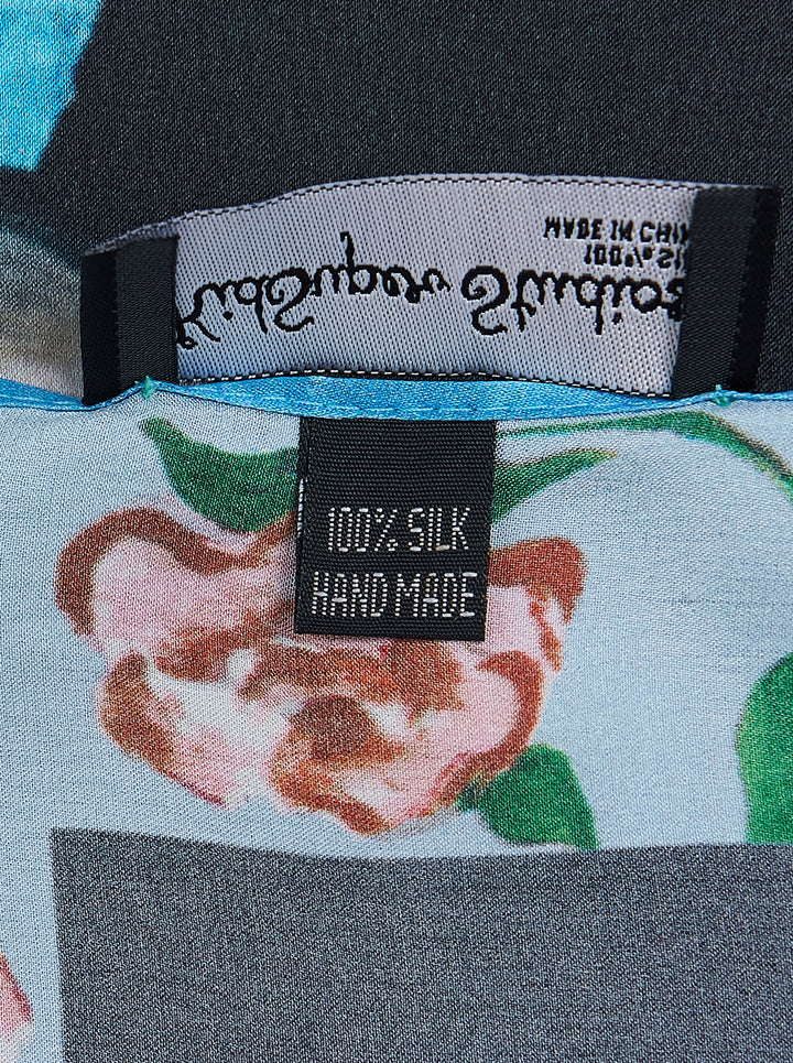 KidSuper Studios Puppet Master silk scarf featuring a painted marionette ballerina in a white and blue tutu on a black ground, framed by a blue border of red roses and script lettering - view 2