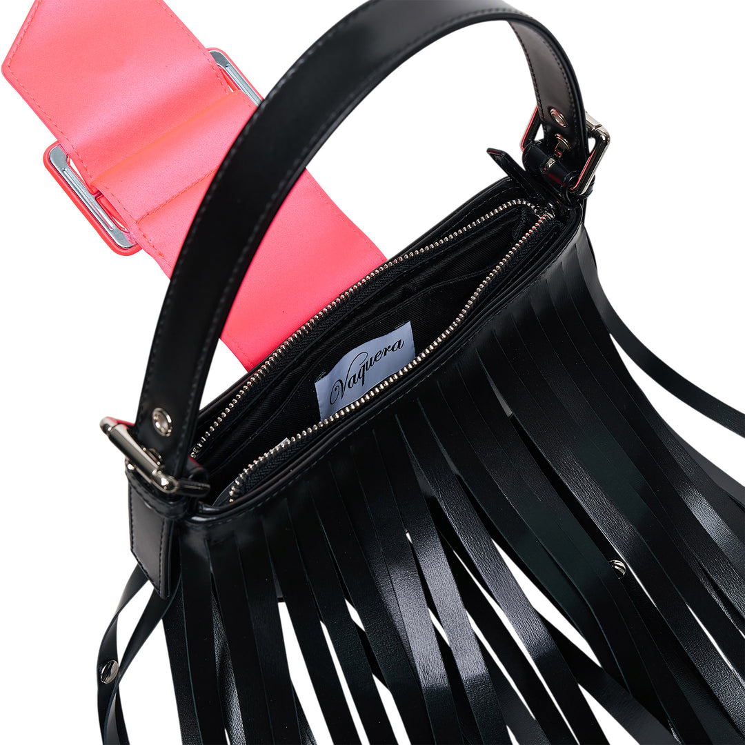 Vaquera Mini Fringe Leather Top Handle Bag in black with cascading studded leather fringe and neon coral buckle closure on a white background