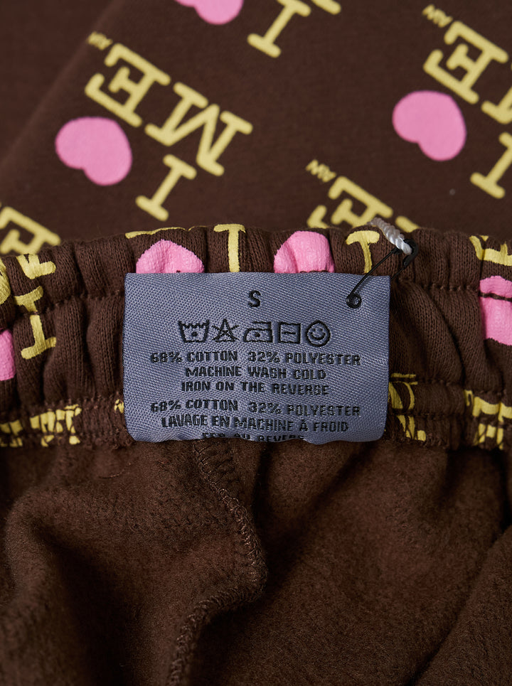 Ashley Williams Choco I Heart Me Mini Skirt in chocolate brown with all-over 'I ♥ ME' logo repeat print in yellow and pink, featuring a fitted A-line silhouette and structured waistband - view 3