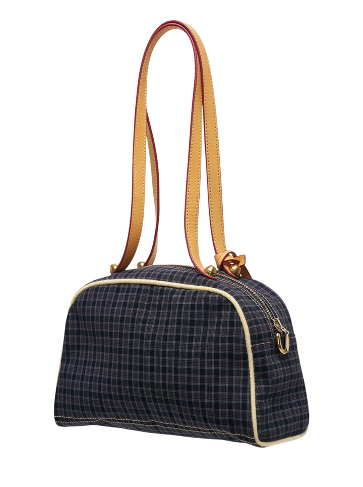 Sultry Virgin Gingham Bowling Bag in dark plaid fabric with tan leather trim, cream topstitching, bird-shaped charm pendant, and a dual-tone shoulder strap with red painted edge - view 2