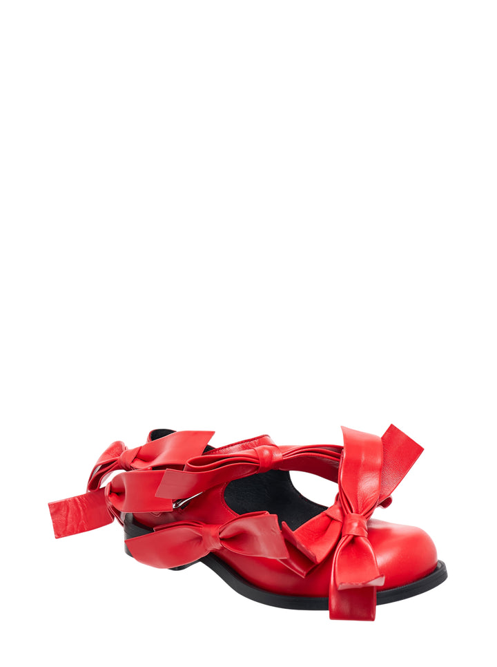 Pair of Phileo Mary Jane Bows flats in red leather with oversized sculptural bows and buckle strap on a black sole - view 2