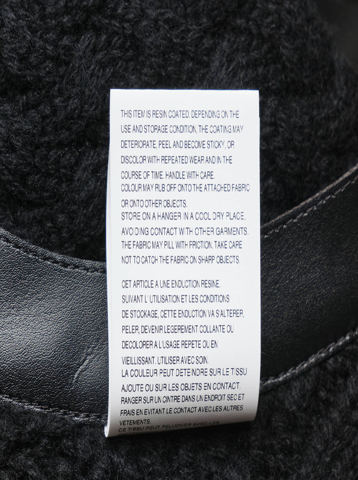 Noir Kei Ninomiya black cable-knit sleeveless vest with structured leather yoke, cutout detailing, and silver press-stud fastening at the rear neckline - view 4