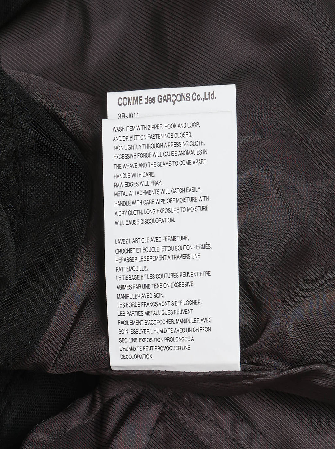 Noir Kei Ninomiya black asymmetrical midi skirt with tiered tulle ruffles and elasticated waistband, shown flat on white background - view 4