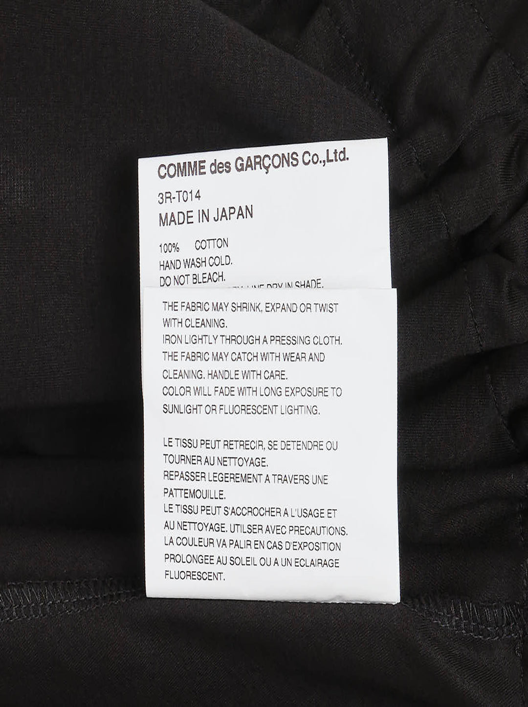 Noir Kei Ninomiya black short-sleeve cotton peplum tee with ruched gathered waistband, drawstring self-ties, and a tiered flared hem, shown flat on a white background - view 4