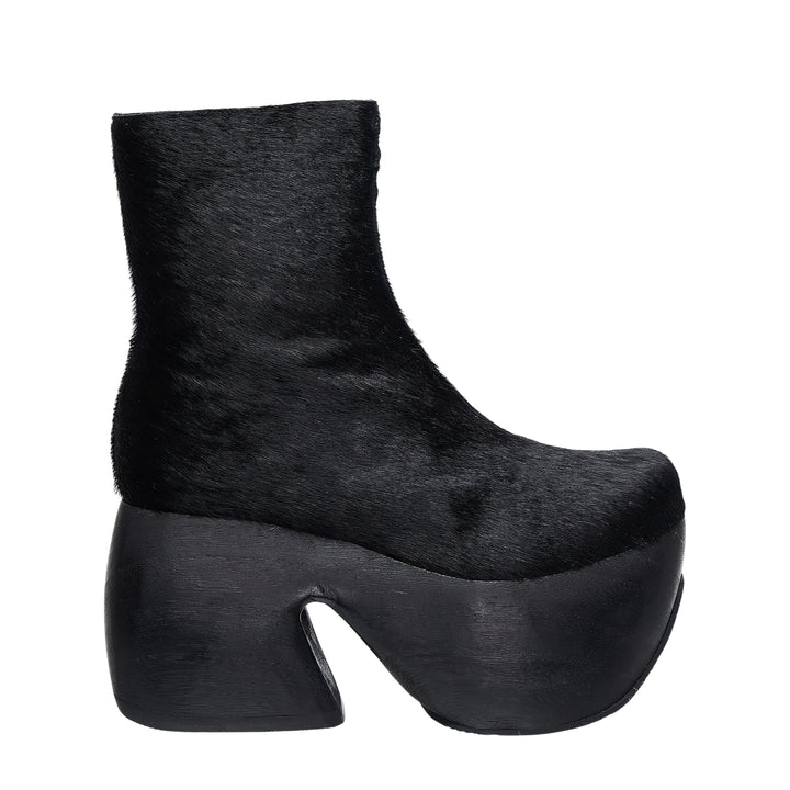 Comme des Garçons x John Fluevog black pony hair platform ankle boot with sculptural cut-out heel, side view on white background