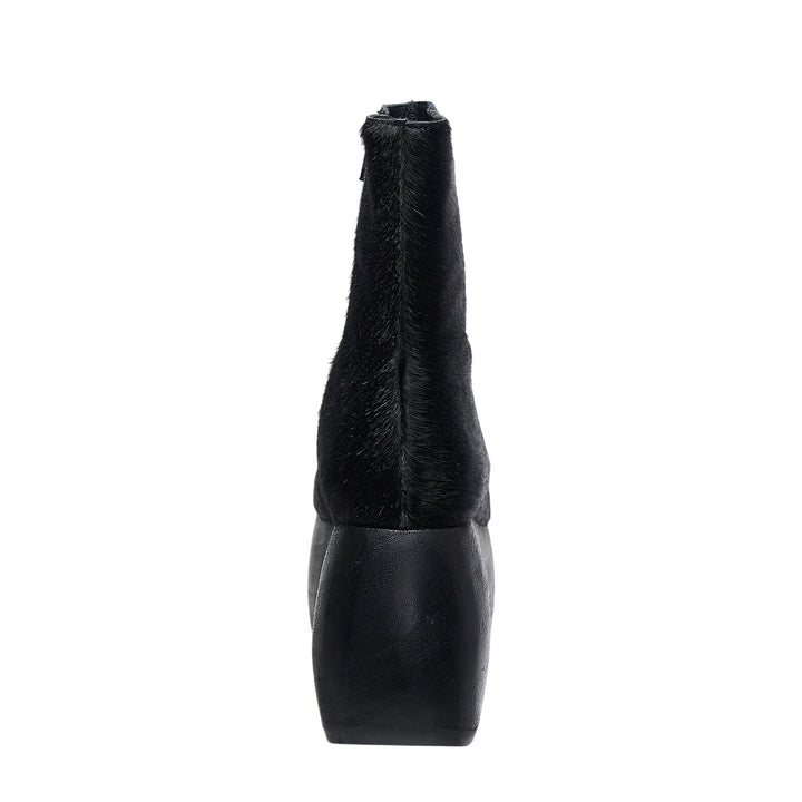 Comme des Garçons x John Fluevog black pony hair platform ankle boot with sculptural cut-out heel, side view on white background