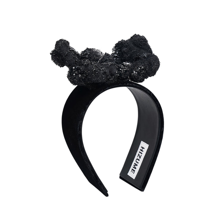 Comme des Garçons x HIZUME black velvet headband with an oversized sculptural beaded and sequined bow embellishment, shown on a white background