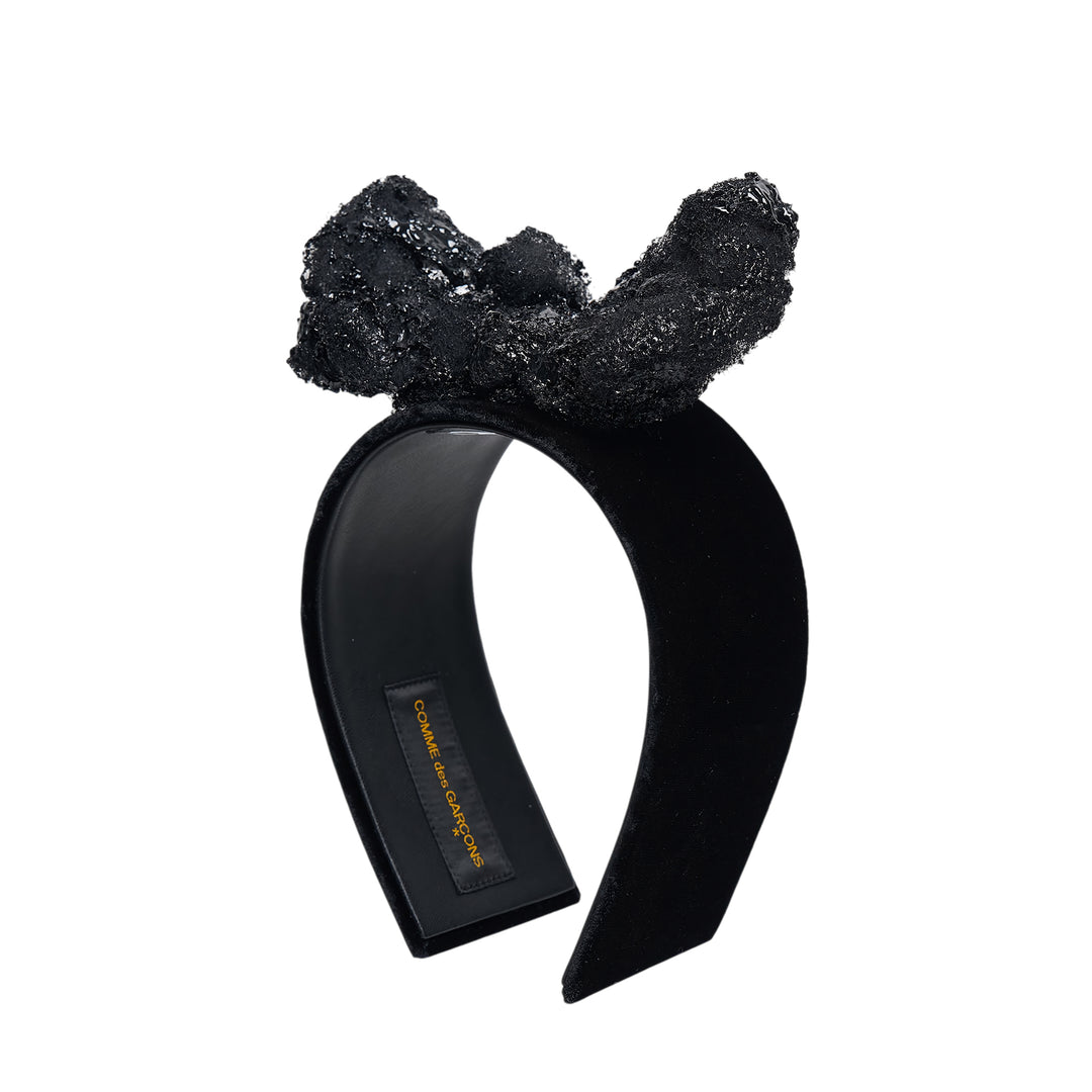 Comme des Garçons x HIZUME black velvet headband with an oversized sculptural beaded and sequined bow embellishment, shown on a white background