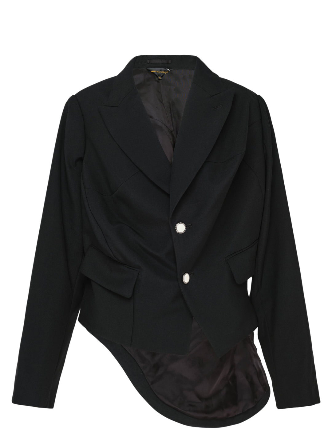 Comme des Garçons black wrap blazer with asymmetric curved hem panel exposing satin lining, peak lapels, jewel-set buttons, and structured shoulders, displayed flat on white background