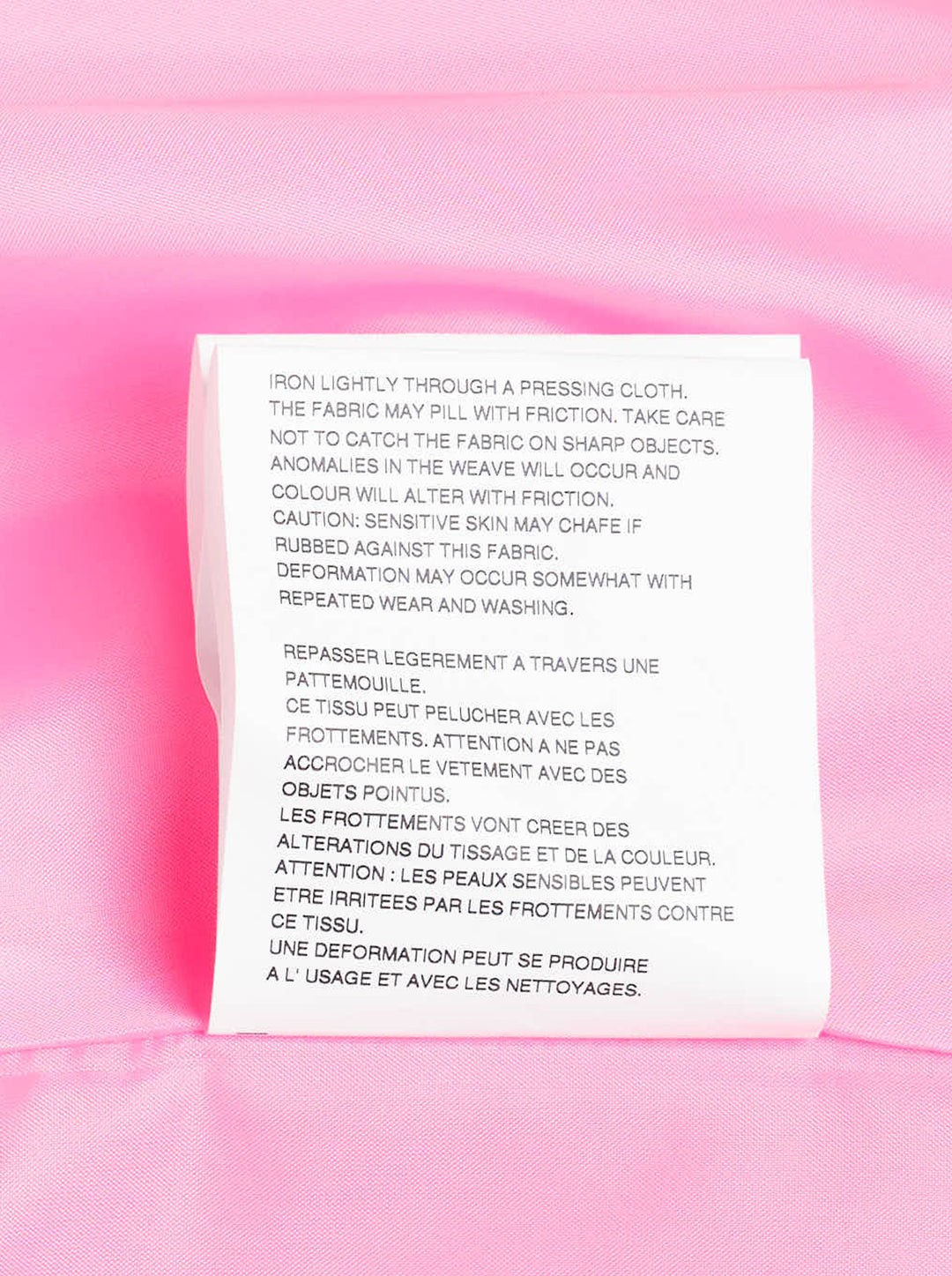 Comme des Garçons hot pink satin single-breasted blazer with large cascading gathered ruffle appliqués across the front, four cream buttons, and a notched lapel, product flat lay on white background - view 4