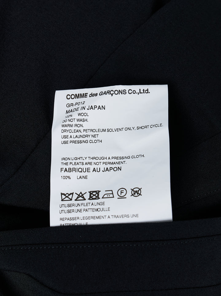 Comme des Garçons black pleated wide-leg trousers with elasticated waistband and fluid, midi-length silhouette, displayed flat on a white background - view 3
