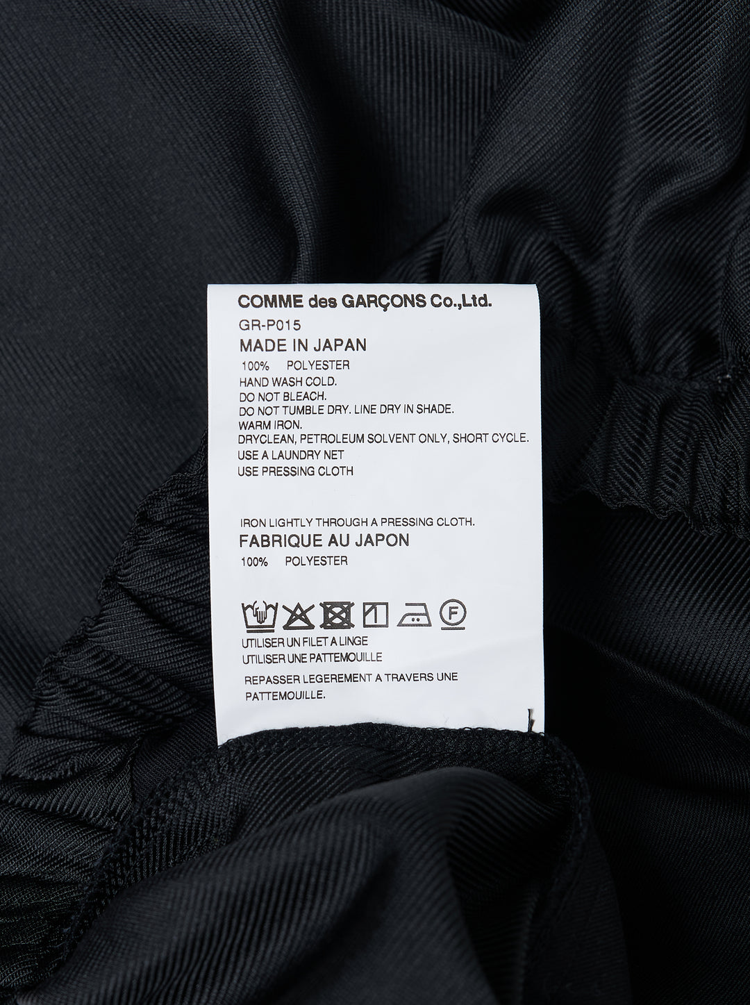 Comme des Garçons black rounded silhouette balloon-leg pants with elasticated waistband and structured vertical seaming, laid flat on white background - view 3