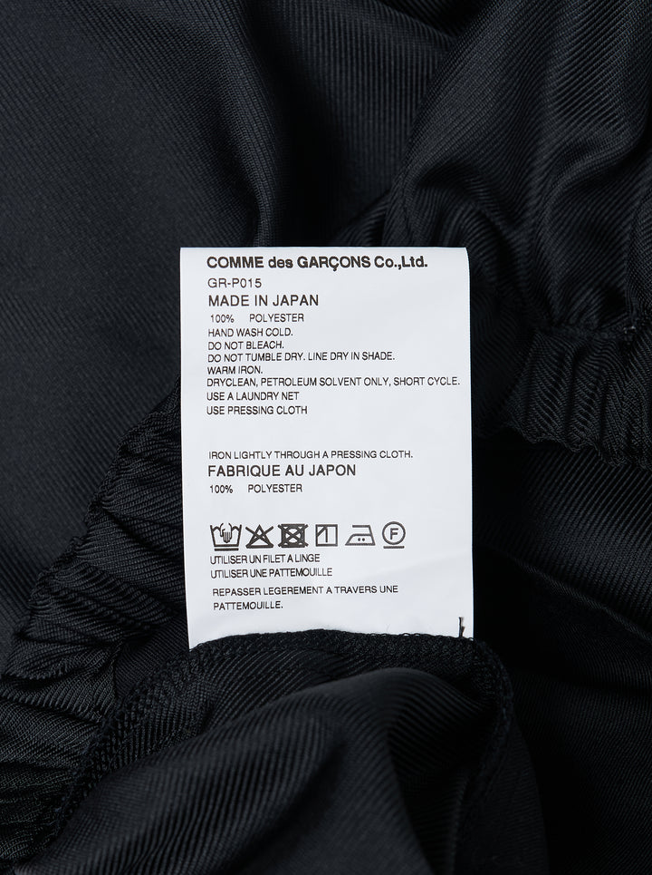 Comme des Garçons black rounded silhouette balloon-leg pants with elasticated waistband and structured vertical seaming, laid flat on white background - view 3