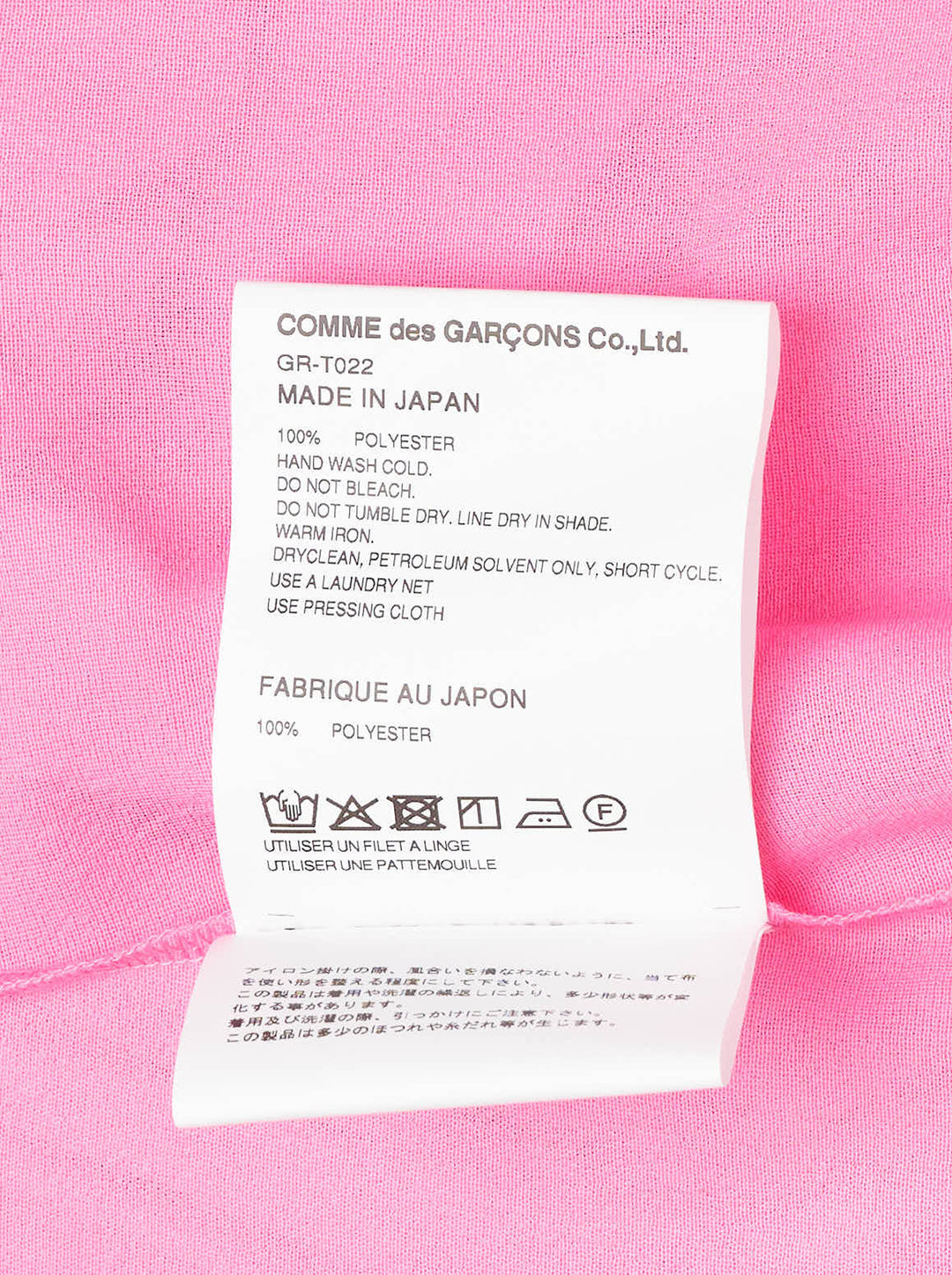 Comme des Garçons bright pink sleeveless tank top with dramatic knotted and gathered ruffle detailing across the lower hem, shown flat on a white background - view 3