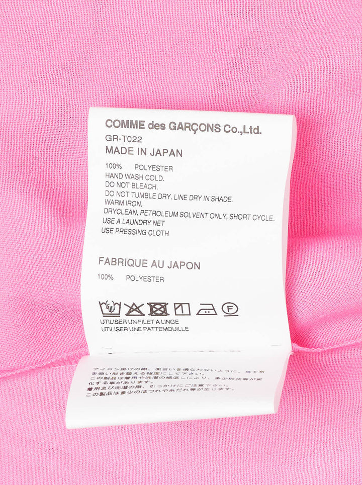 Comme des Garçons bright pink sleeveless tank top with dramatic knotted and gathered ruffle detailing across the lower hem, shown flat on a white background - view 3
