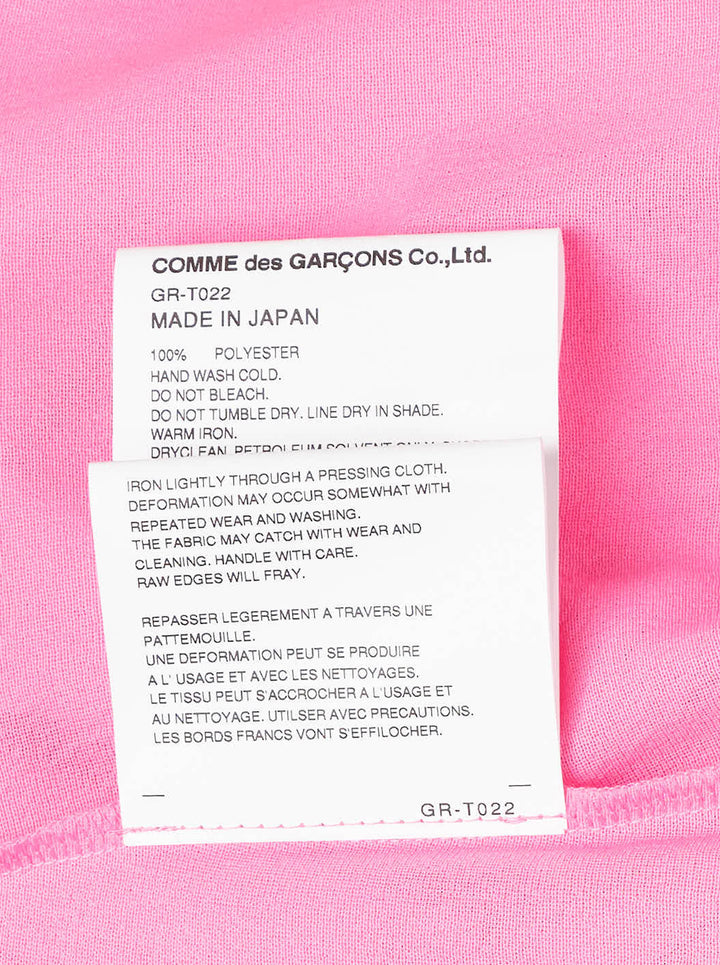 Comme des Garçons bright pink sleeveless tank top with dramatic knotted and gathered ruffle detailing across the lower hem, shown flat on a white background - view 4