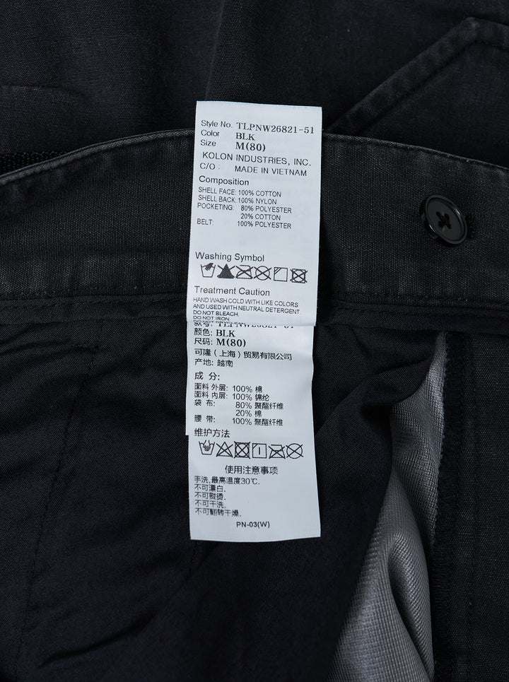 Jiyong Kim washed black multi-pocket cargo trousers with curved wide-leg silhouette, flap pockets and black buckle belt, shown front view - view 4