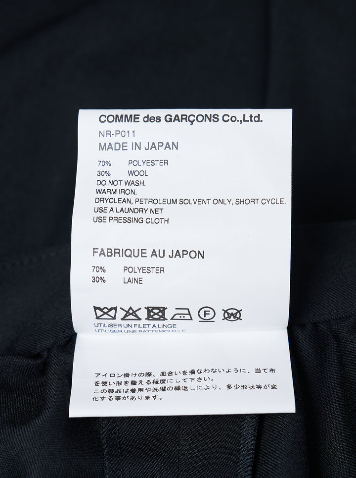Comme des Garçons Girl black tailored knee-length shorts with wide-leg silhouette, soft pleating at the high-rise waistband, single-button closure, and cuffed hems - view 3