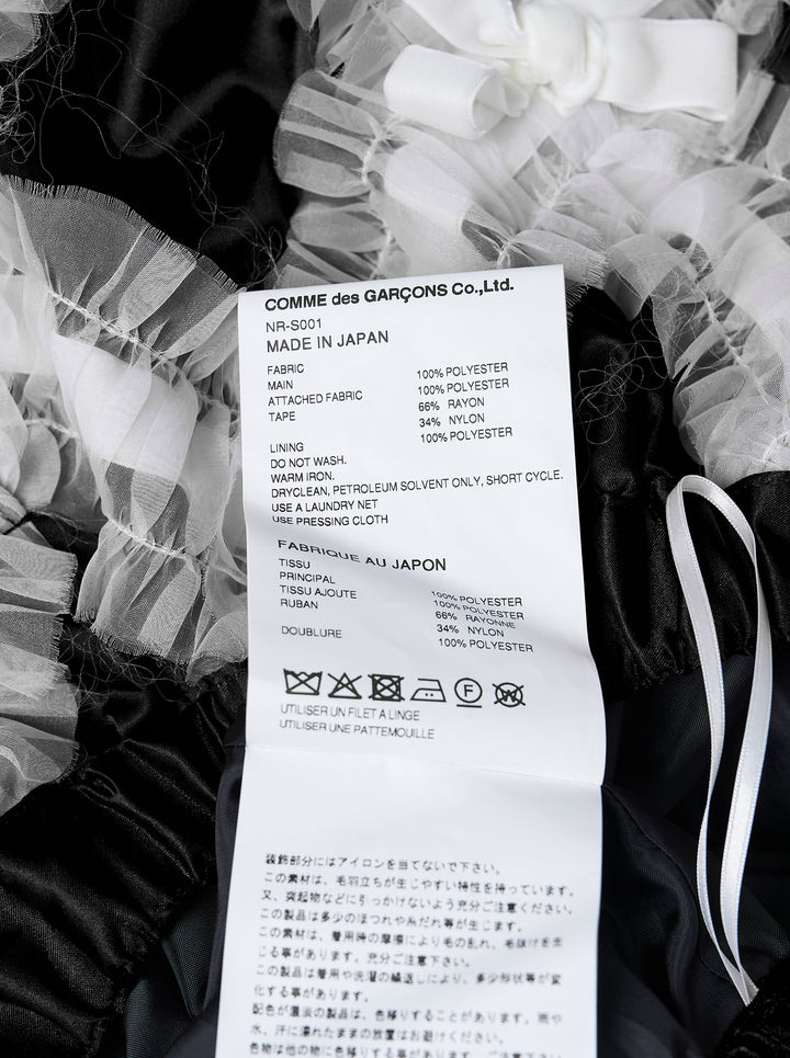 Comme des Garçons Girl black satin A-line skirt with white criss-cross tulle lattice overlay and satin ribbon bows, gathered flared hem, white background - view 3