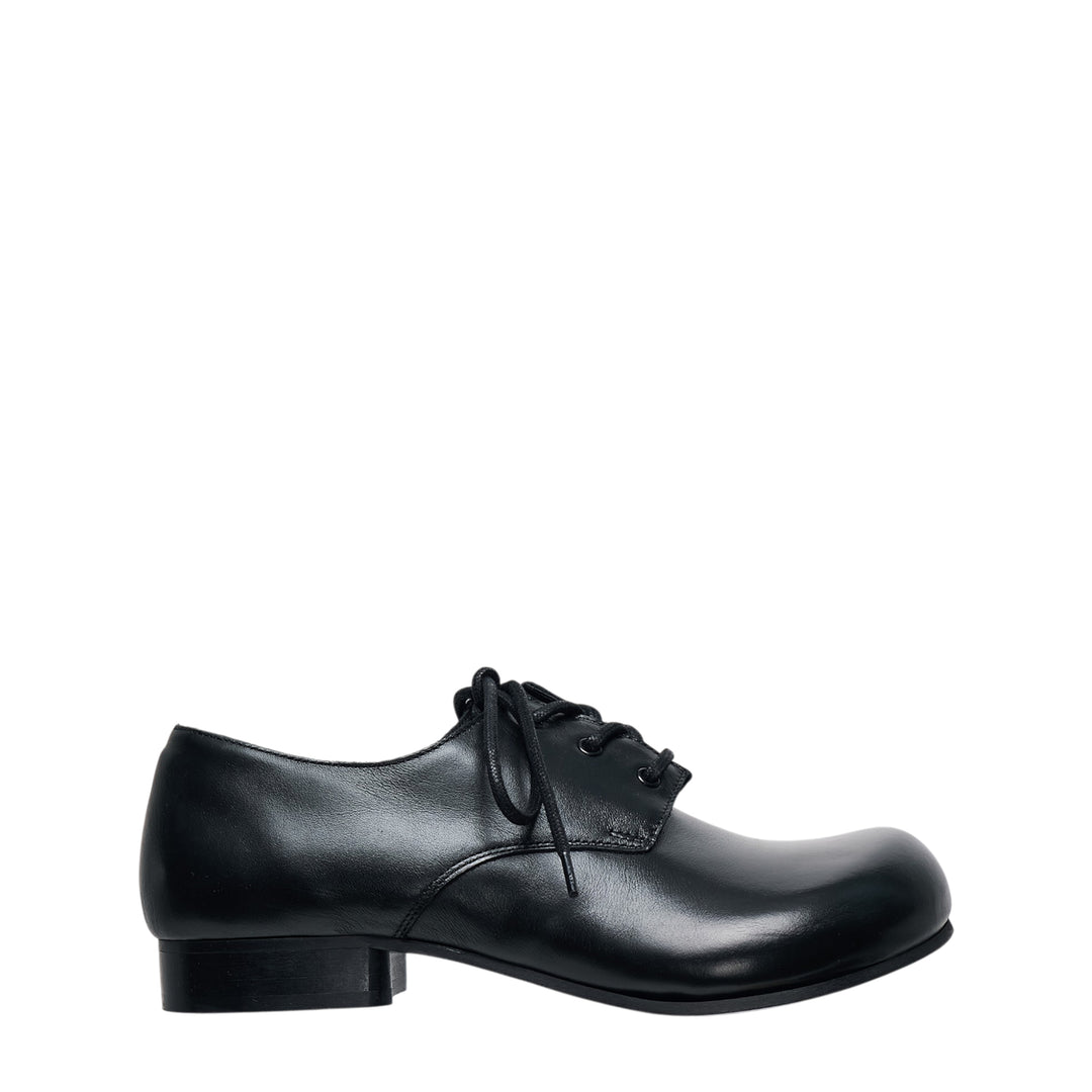 Comme des Garçons Comme des Garçons black leather lace-up Oxford shoe with sculptural round toe and low block heel, side profile view
