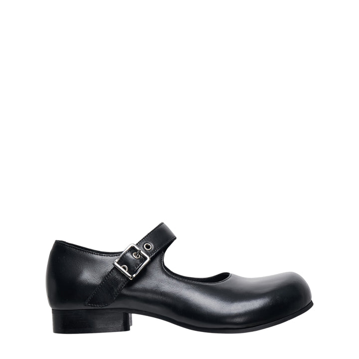 Comme des Garçons Comme des Garçons black leather Mary Jane flat with sculptural round toe and silver buckle instep strap, side profile view