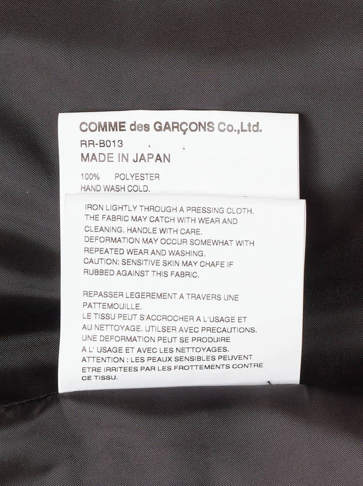 Comme des Garçons Comme des Garçons black satin blouse with dramatic tiered gathered ruffle bib front, long sleeves, point collar, and button fastening, on a white background - view 4