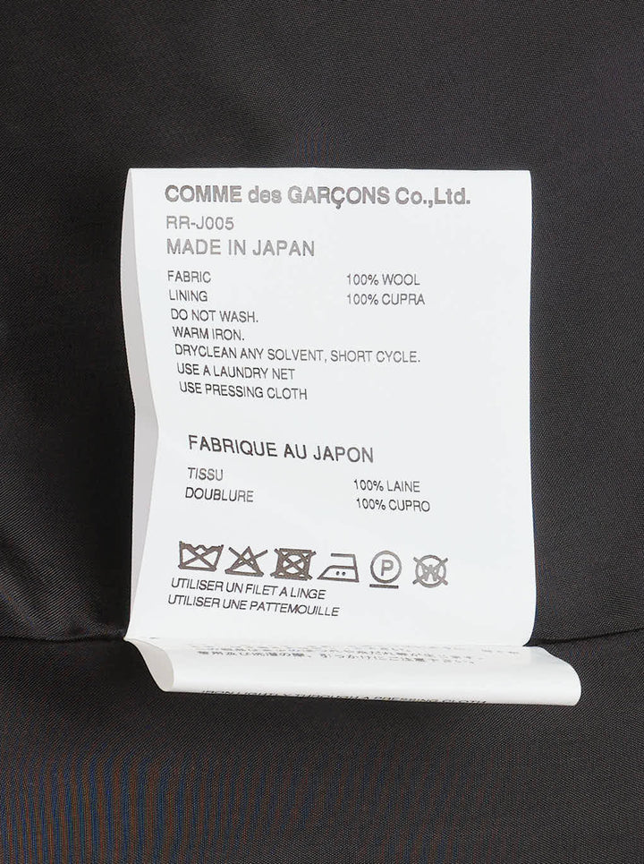 Comme des Garçons Comme des Garçons charcoal grey single-breasted tailored blazer with deconstructed double-lapel detail and three-button closure, styled flat on a white background - view 3
