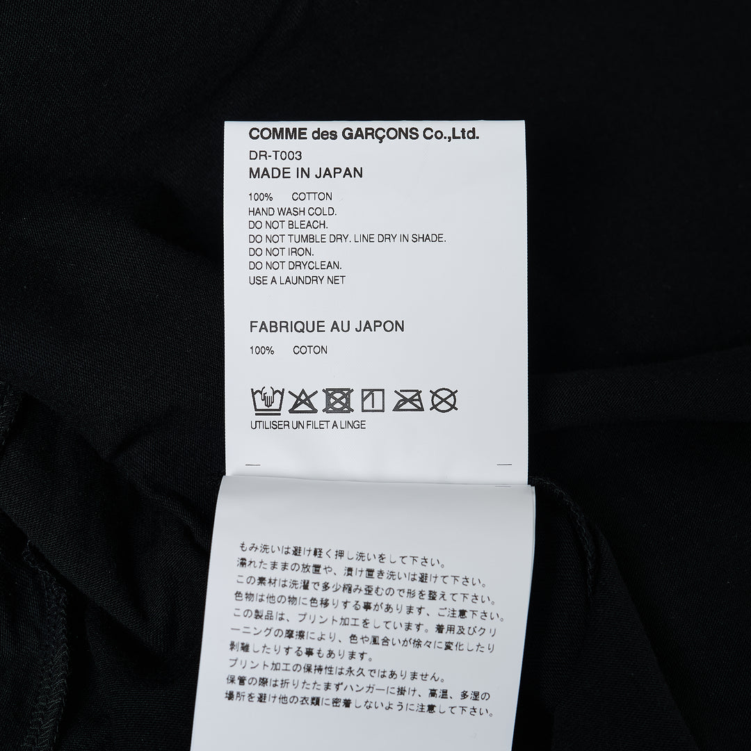 Comme des Garçons Homme Deux black cotton jersey tee with abstract body-print graphic in purple and yellow across the chest, crew neck, short sleeves, relaxed fit