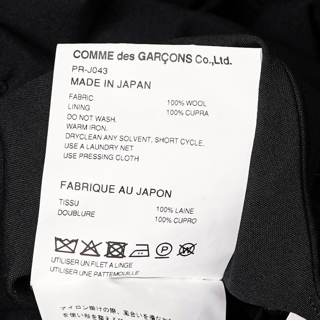Comme des Garçons Homme Plus black wool tropical jacket with dramatic sculptural ruffles cascading across the chest and shoulders, long sleeves, and a notched lapel collar, displayed on a white background - view 3