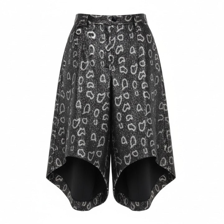 Comme des Garçons Homme Plus wide-leg pants in dark metallic polyester jacquard with an allover open-heart print and dramatically flared curved hem