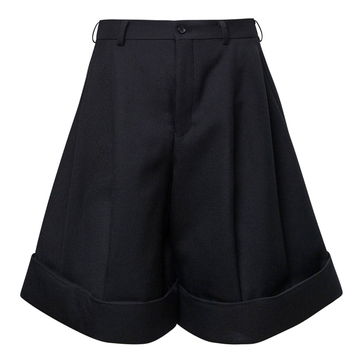 Comme des Garçons Homme Plus black double weave wool wide-leg shorts with deep pleats, button fly, and folded turn-up cuffs, shown flat on white background