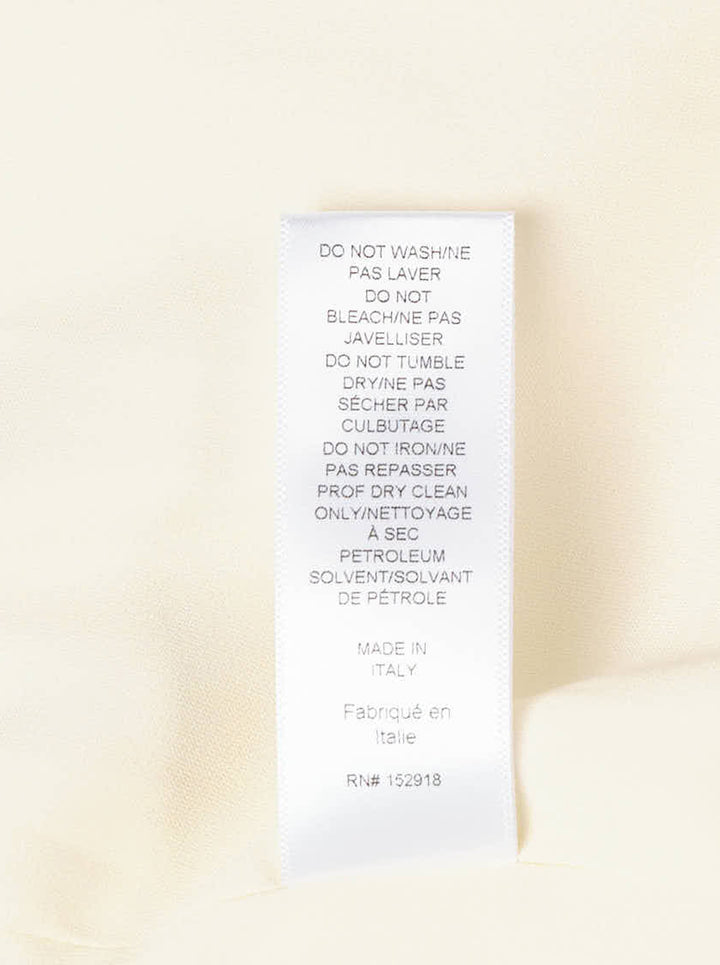 Carolina Herrera ivory sleeveless boatneck midi dress with ruched asymmetrical hem and self-tie bow detail, displayed flat on white background - view 4