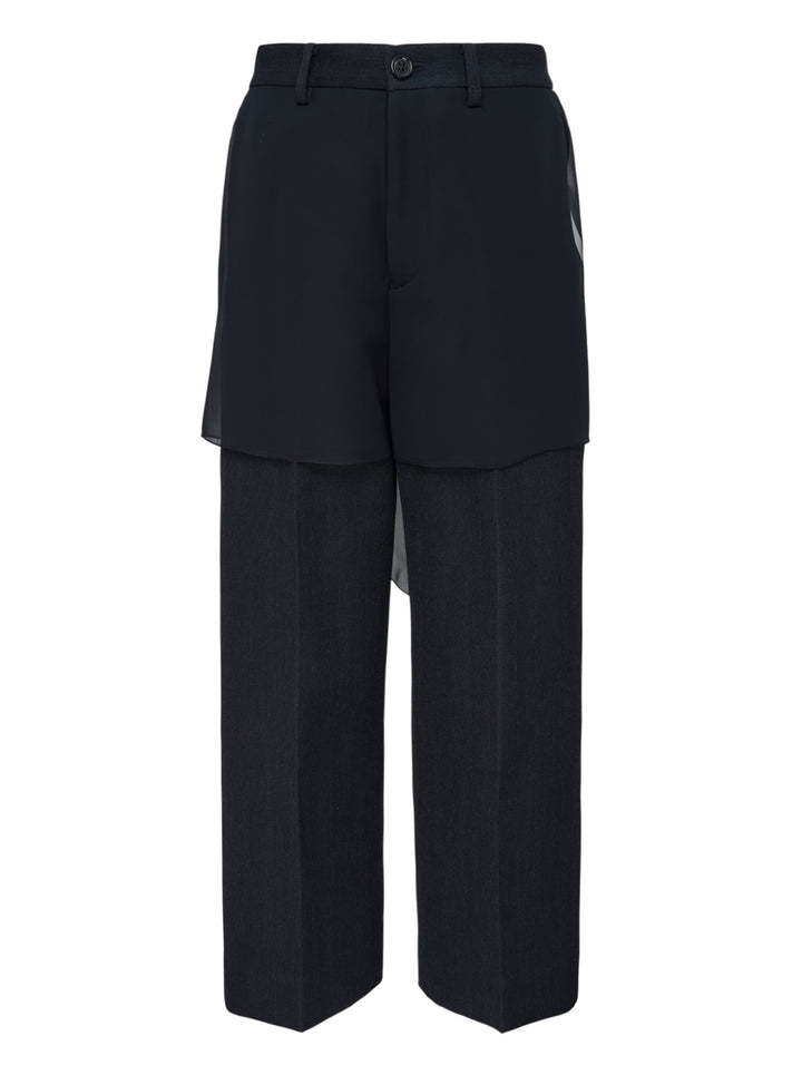 Undercover layered trousers in black and charcoal with a sheer overlay panel and straight-leg cut, front view