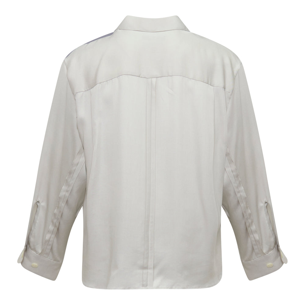 Undercover Cindy Sherman Long Sleeve Shirt laid flat, featuring an all-over photographic print of Cindy Sherman with white-blonde hair and a dark coat, on a light grey shirt with button-front closure and chest flap pocket - view 2