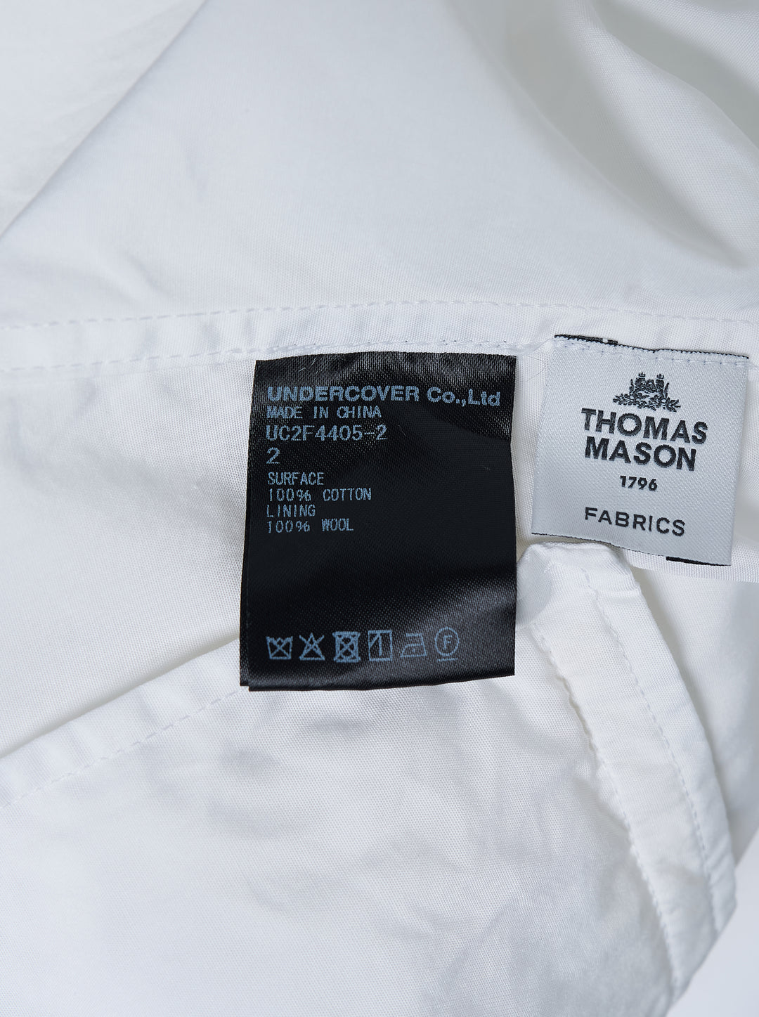 Undercover white long sleeve pullover shirt with band collar, half-button placket, and two flap pockets at the waist - view 3