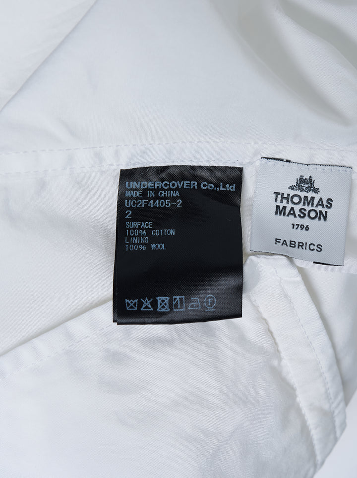 Undercover white long sleeve pullover shirt with band collar, half-button placket, and two flap pockets at the waist - view 3