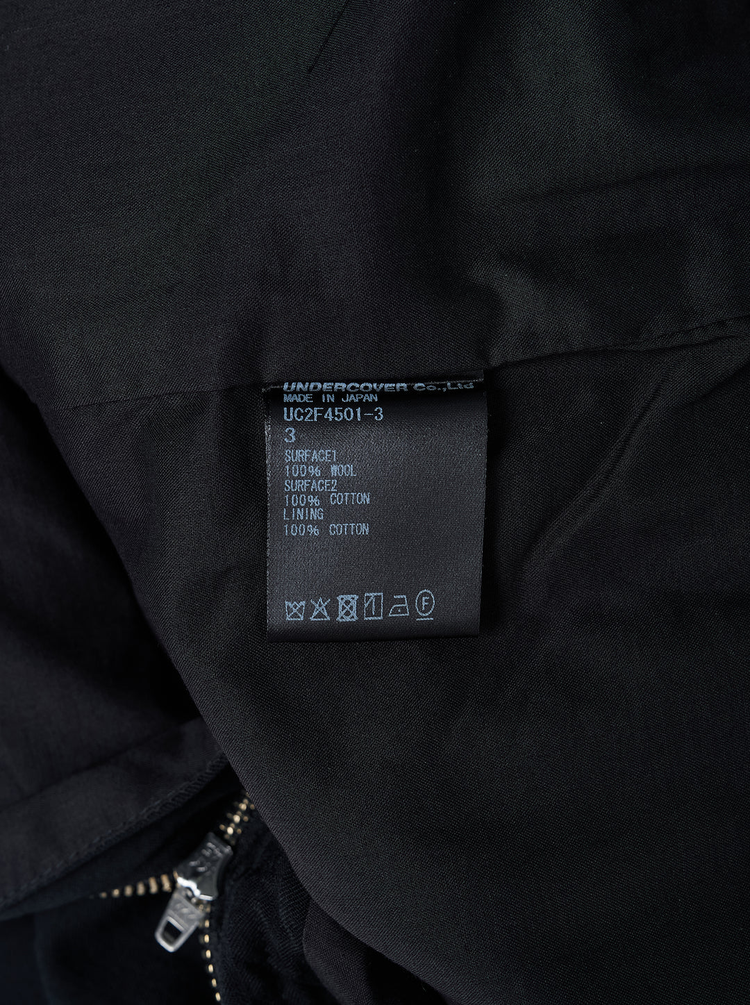 Undercover black stripe wool pants with tonal pinstripe texture, button waistband and straight leg, shown front view - view 3