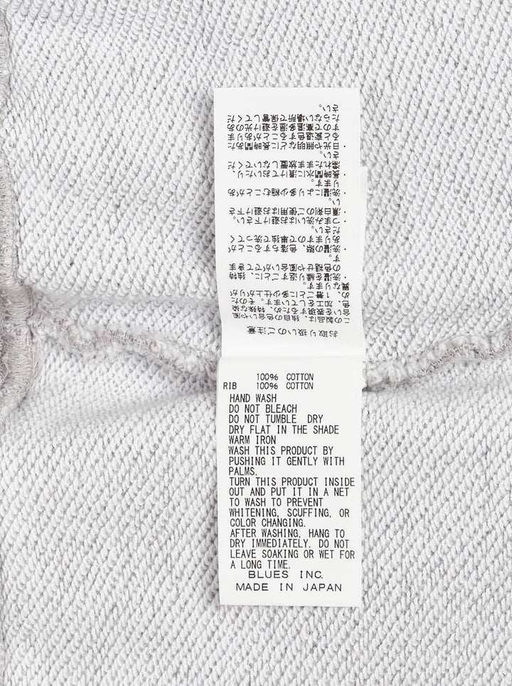 Grey marl crewneck sweatshirt with an illustrated fox in a patchwork denim jacket and jeans and Kuro Kitsuné Paris lettering on the chest - view 3