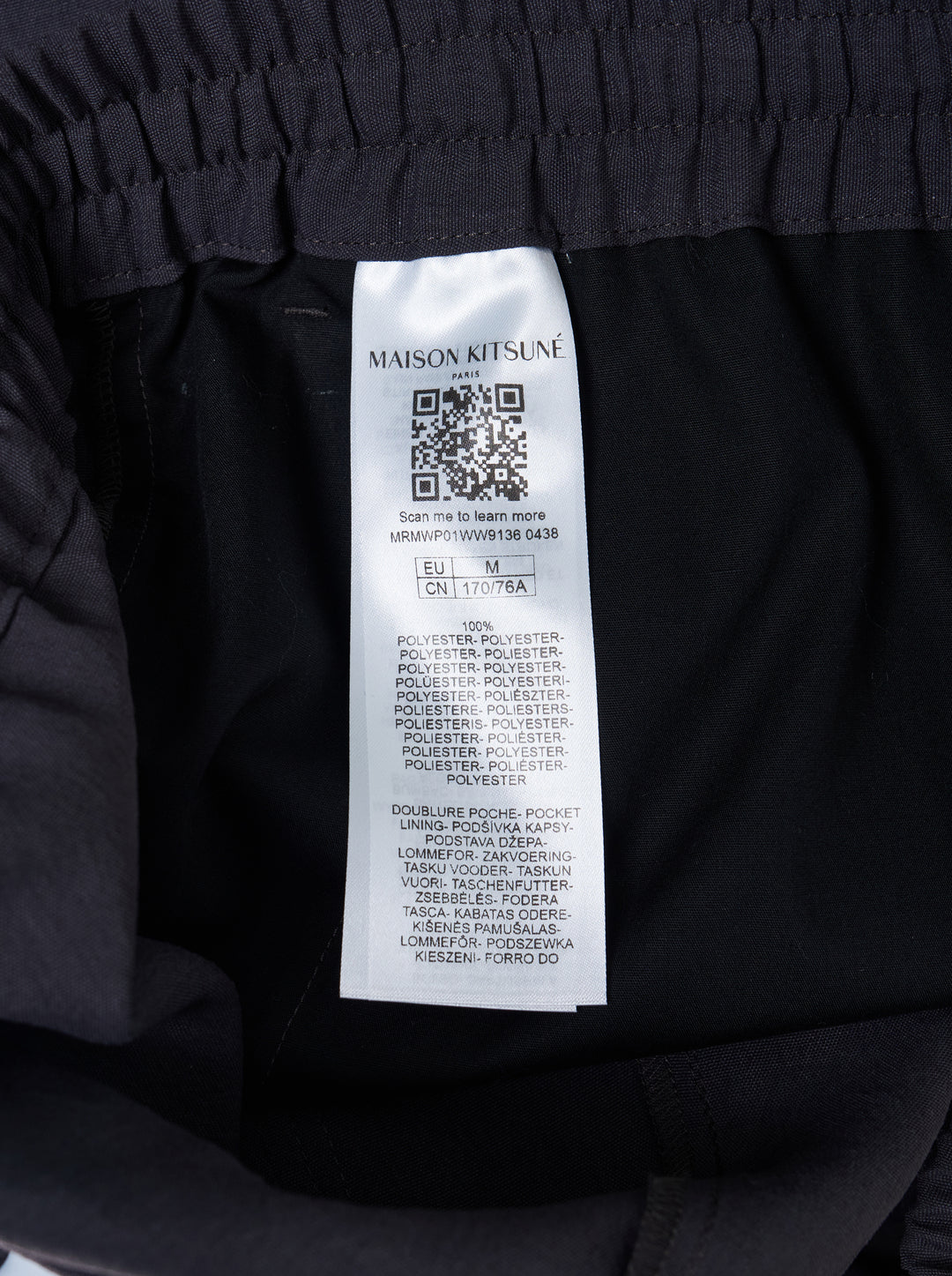 Maison Kitsuné Elasticated Cargo Pants in dark charcoal navy, featuring a wide-leg silhouette, elasticated waistband, articulated knee panelling, and a flap cargo pocket on the leg - view 3
