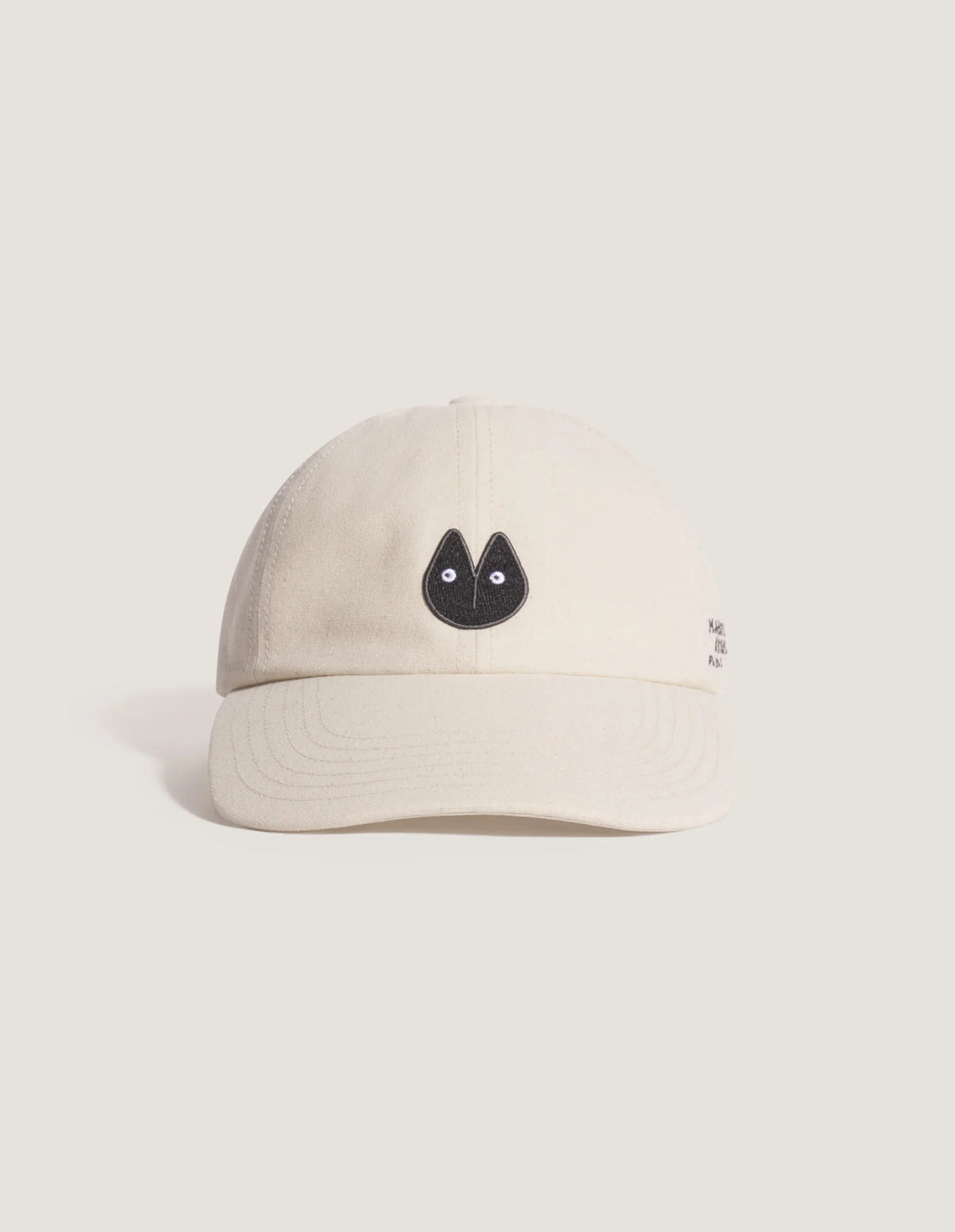 Maison Kitsuné Fortune Fox Cap in cream with an embroidered black fox head patch on the front and a curved brim