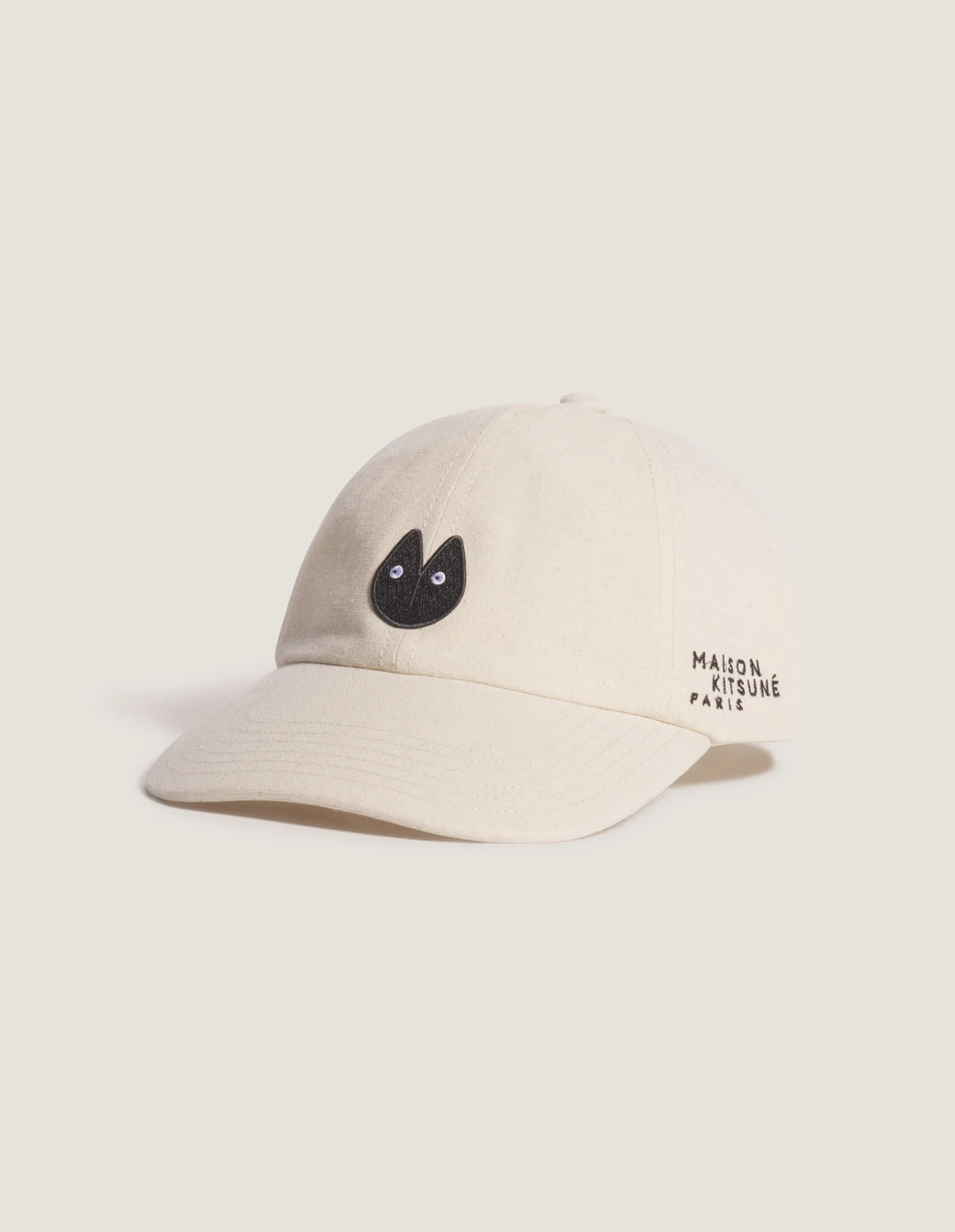 Maison Kitsuné Fortune Fox Cap in cream with an embroidered black fox head patch on the front and a curved brim - view 2