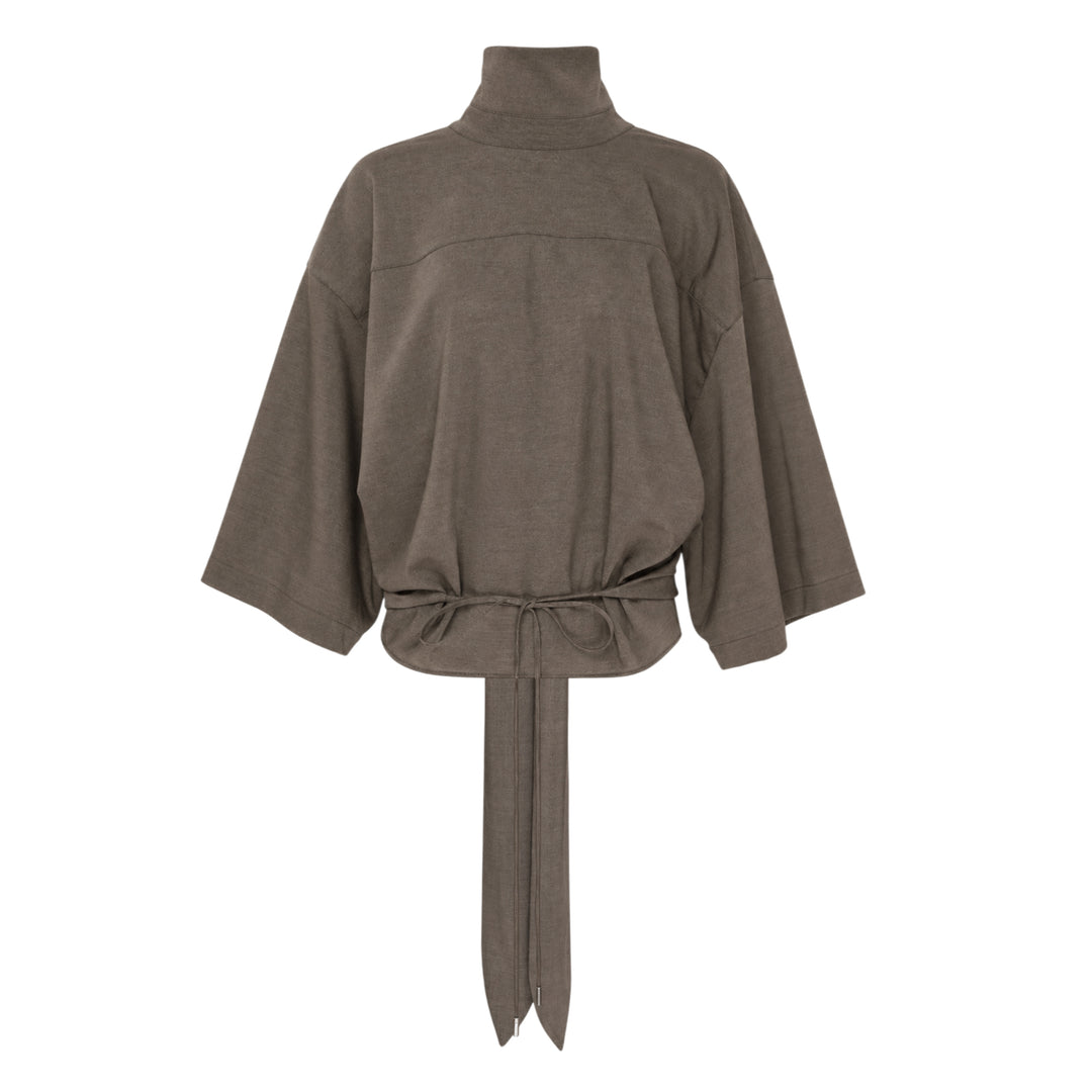 Jacquemus Havana Woven Belted Top in taupe, featuring a high turtleneck collar, wide elbow-length sleeves, and a long self-tie fabric belt at the gathered hem, displayed flat on a white background