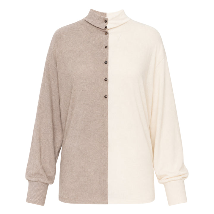 Jacquemus Losange two-tone knit top with vertical colourblock split in oat and cream, featuring a mock turtleneck collar, snap-button placket, and blouson long sleeves with ribbed cuffs